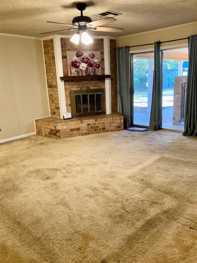 unfurnished living room featuring carpet floors, a textured ceiling, and a brick fireplace