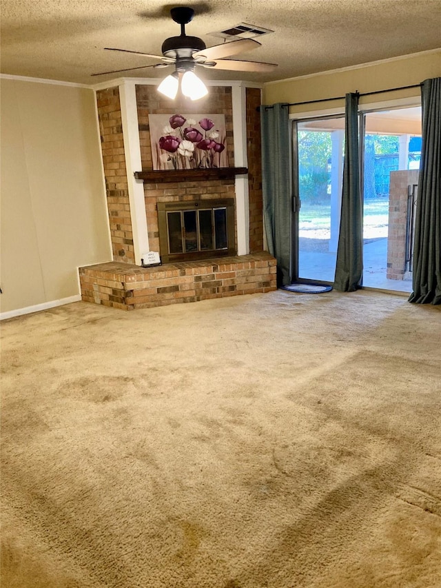 unfurnished living room featuring carpet floors, a textured ceiling, and a brick fireplace