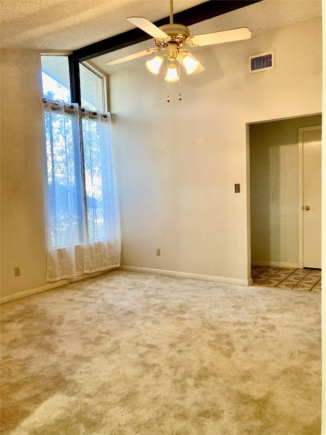 spare room with carpet, a textured ceiling, and ceiling fan