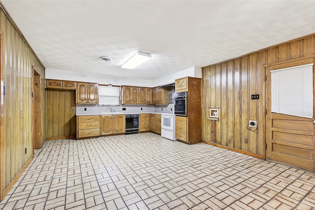 kitchen with white range oven, oven, wooden walls, and sink