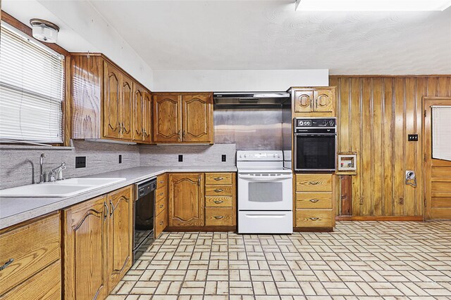 unfurnished living room with ceiling fan, built in features, wooden walls, and a brick fireplace