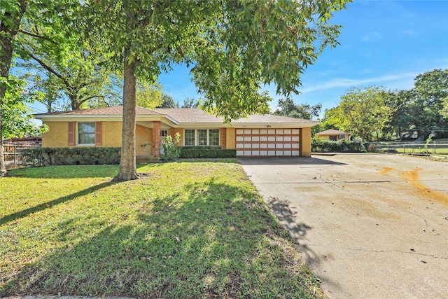 ranch-style house with a front yard and a garage