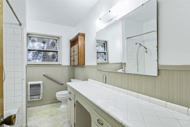 bathroom featuring heating unit, vanity, and toilet