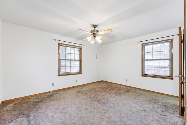 unfurnished room with ceiling fan, carpet, and a healthy amount of sunlight