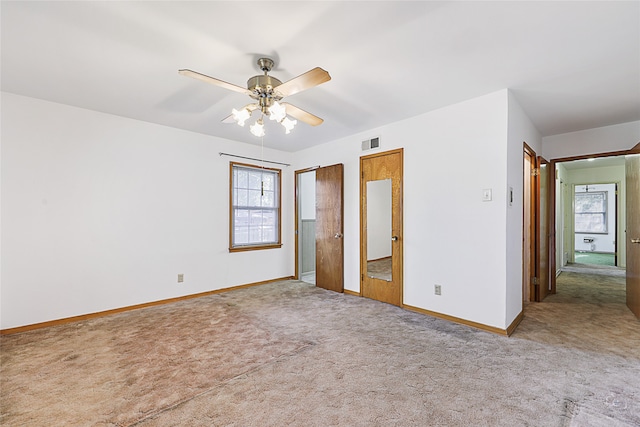 unfurnished bedroom featuring ceiling fan and carpet