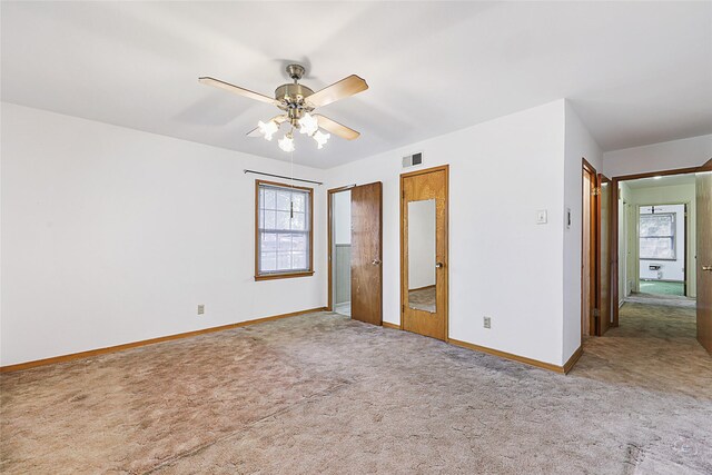 unfurnished bedroom featuring ceiling fan and carpet