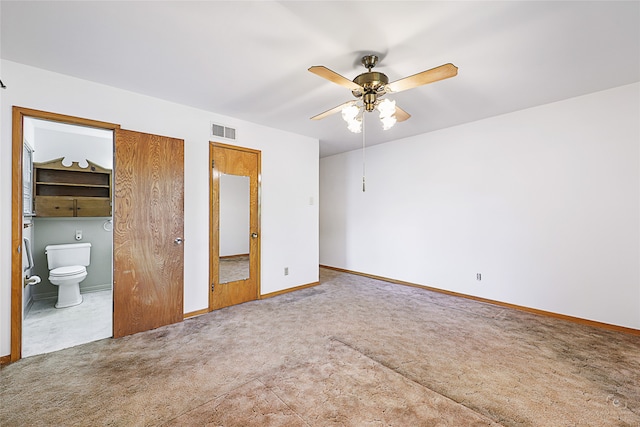 unfurnished bedroom featuring ensuite bath, ceiling fan, and carpet