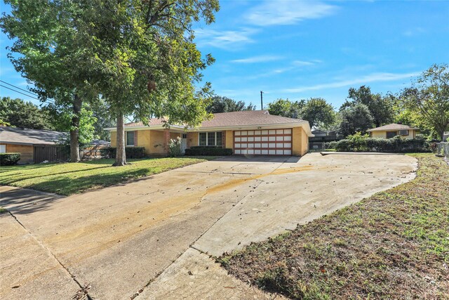 ranch-style house with a front lawn and a garage