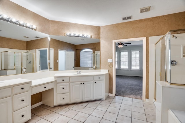 bathroom featuring tile patterned flooring, ceiling fan, a shower with shower door, and vanity