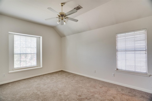 carpeted empty room with vaulted ceiling and ceiling fan