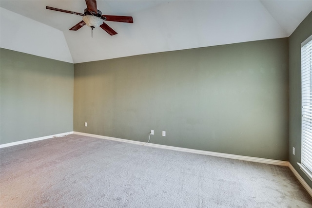 carpeted empty room with ceiling fan, lofted ceiling, and a wealth of natural light