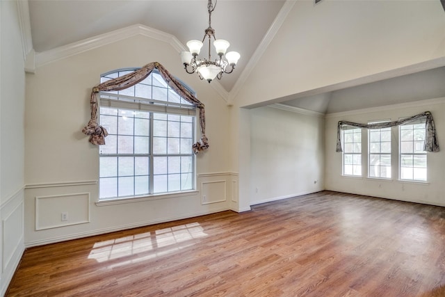 unfurnished dining area featuring hardwood / wood-style flooring, ornamental molding, and a chandelier