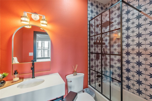 full bathroom featuring vanity, toilet, and bath / shower combo with glass door