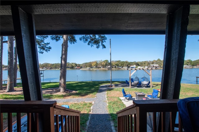 deck featuring ceiling fan and a water view