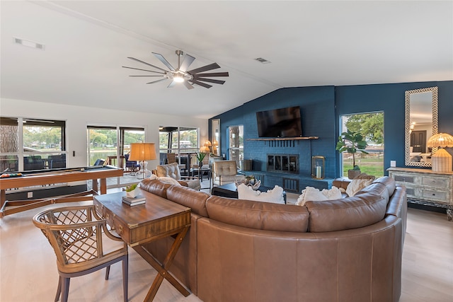 living room with a healthy amount of sunlight, a brick fireplace, lofted ceiling, and pool table