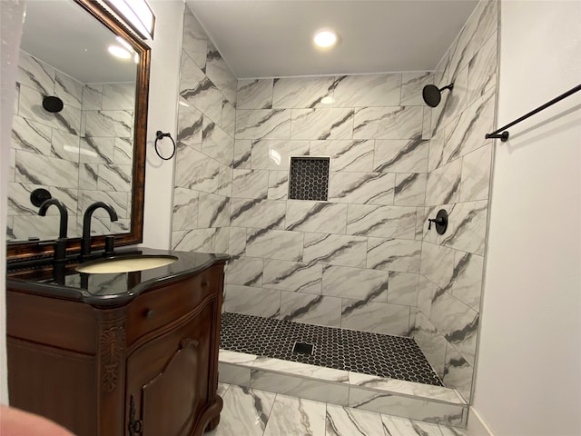 bathroom featuring vanity and a tile shower