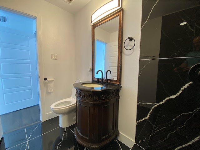 bathroom featuring tile patterned floors, vanity, and toilet