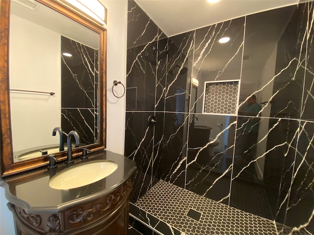 bathroom with vanity and tiled shower