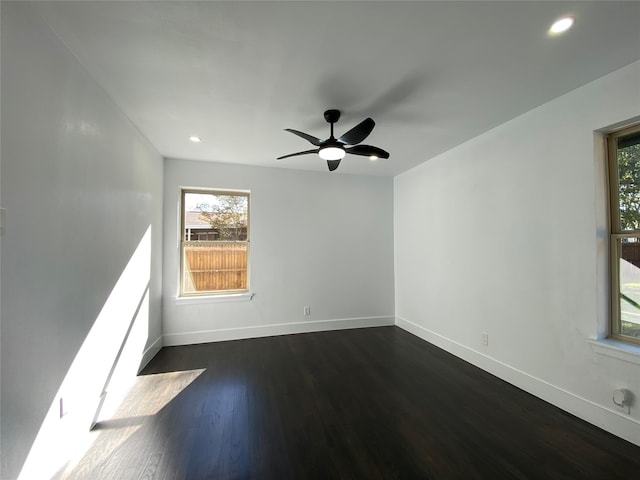 unfurnished room with ceiling fan and dark wood-type flooring