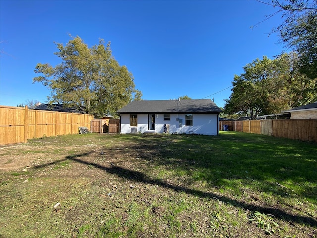 rear view of property with a yard