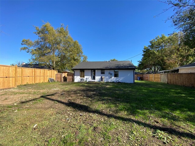 rear view of property with a yard