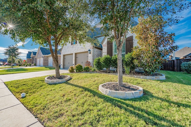 view of front facade featuring a front yard and a garage