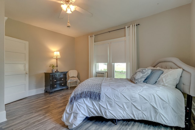 bedroom with ceiling fan, cooling unit, and hardwood / wood-style flooring