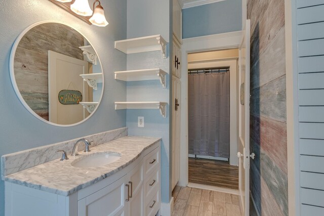 bathroom featuring curtained shower, vanity, and hardwood / wood-style flooring