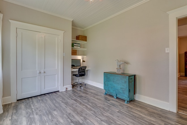 home office with light wood-type flooring and crown molding