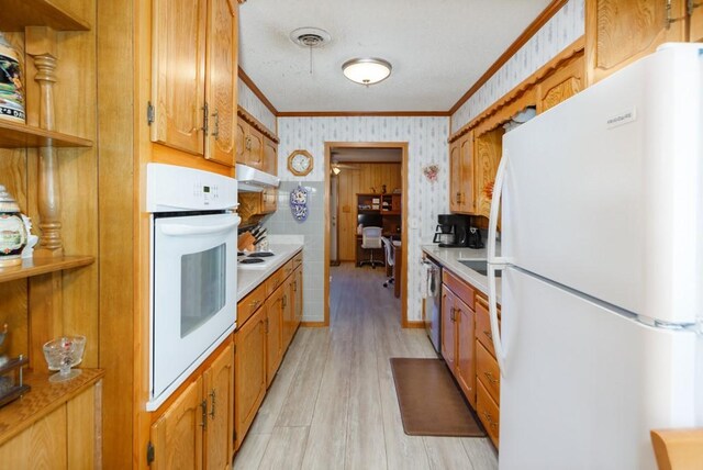 kitchen with light wood-type flooring, white appliances, and crown molding