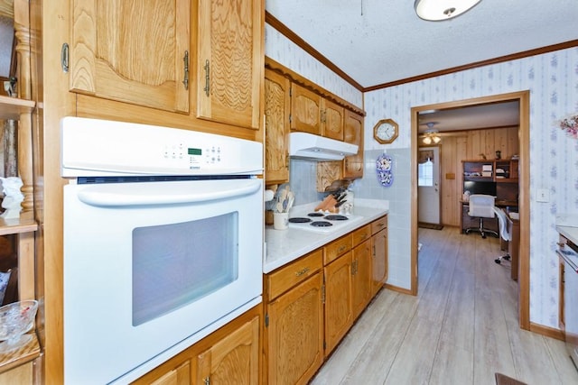 kitchen featuring white appliances, light hardwood / wood-style floors, and ornamental molding