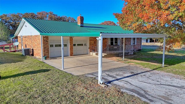 single story home featuring a front lawn, a garage, a carport, and cooling unit
