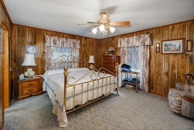 bedroom with carpet floors, ceiling fan, and wood walls