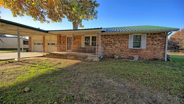 view of front of property featuring a garage, covered porch, a front yard, and a carport