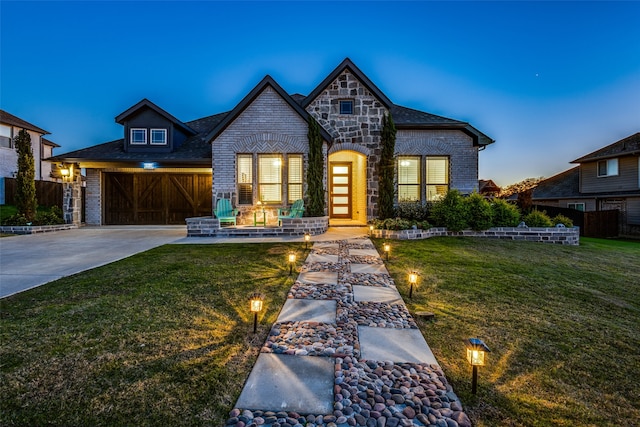 view of front of home featuring a garage and a lawn