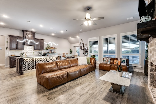 living room with ceiling fan and light hardwood / wood-style flooring