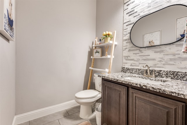 bathroom featuring tile patterned flooring, vanity, and toilet