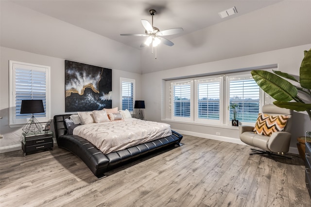 bedroom featuring ceiling fan, vaulted ceiling, and light wood-type flooring