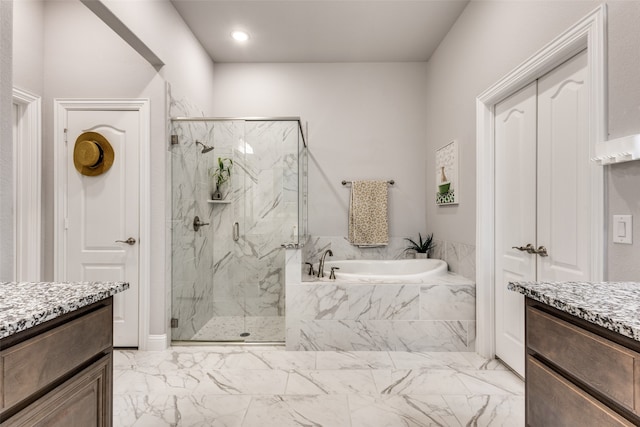 bathroom featuring shower with separate bathtub and vanity