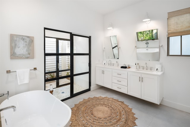 bathroom featuring a bathing tub, plenty of natural light, and concrete flooring