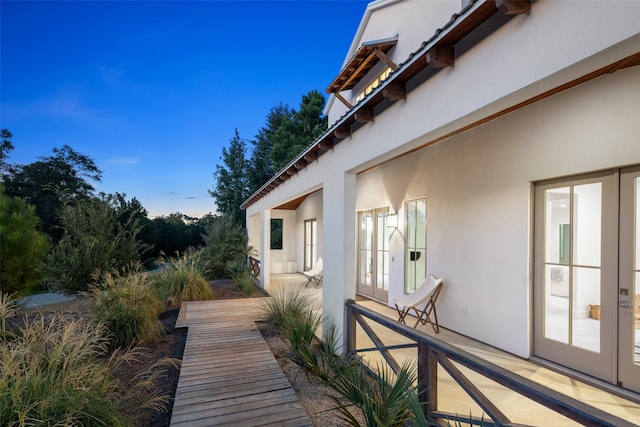 view of side of property with french doors