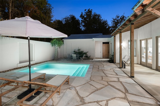 view of pool with french doors and a patio area