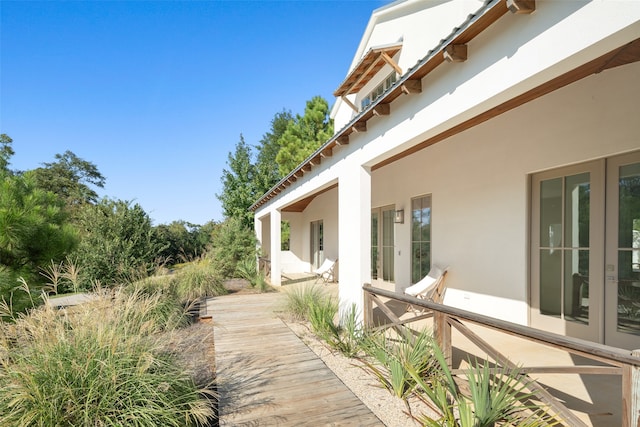 view of property exterior featuring french doors