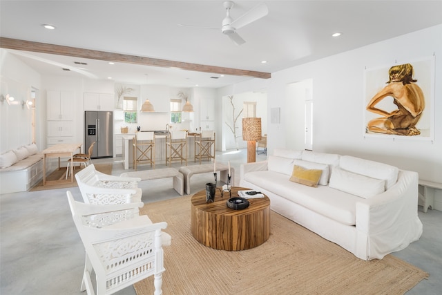 living room featuring beam ceiling and ceiling fan