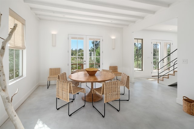 dining room with beamed ceiling, plenty of natural light, and french doors