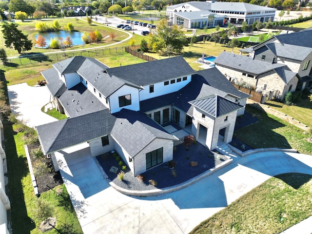 birds eye view of property with a water view