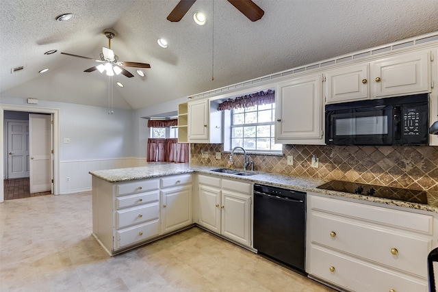 kitchen with white cabinetry, sink, a textured ceiling, lofted ceiling, and black appliances