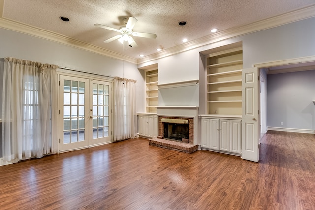 unfurnished living room with french doors, a textured ceiling, hardwood / wood-style flooring, and built in features