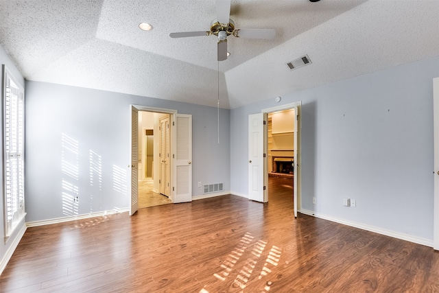 interior space with ceiling fan, hardwood / wood-style floors, and vaulted ceiling