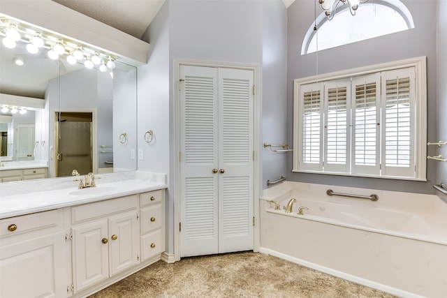 bathroom featuring vanity, separate shower and tub, lofted ceiling, and a textured ceiling